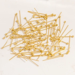 Close-up of bulk 18K gold-plated ball pins for handmade jewelry DIY crafts