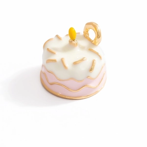 Detailed view of handmade cake pendant with white enamel frosting and pink base