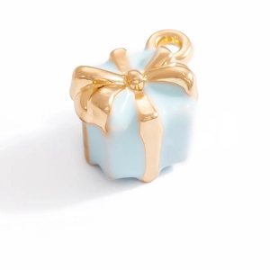 Detailed view of light blue gift box charm with a gold ribbon bow and hanging loop