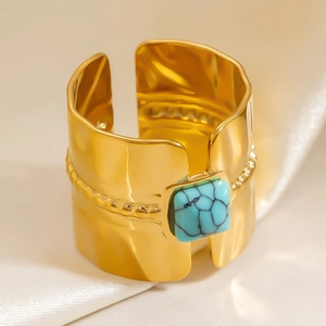 Macro shot of 18k gold plated hammered ring featuring a square turquoise stone and beaded edges