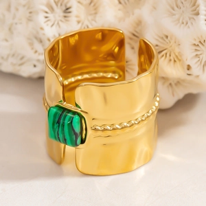 Macro view of wide gold hammer textured ring featuring square malachite stone inlay