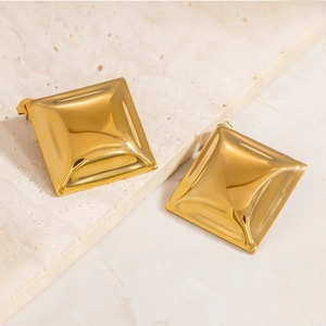Modern irregular square gold-plated stud earrings on a minimalist stone texture background