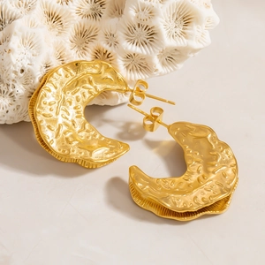 Macro shot of 18k gold plated stainless steel stud earrings with irregular hammer texture