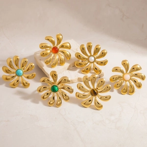 Detailed close-up of 18k gold plated flower rings with various natural stone centers