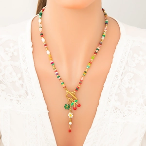 Colorful beaded necklace with freshwater pearls and cherry floral pendants on lace background