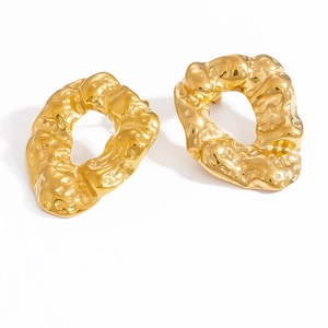 Detailed close-up of 18k gold-plated irregular geometric earrings with hammered texture