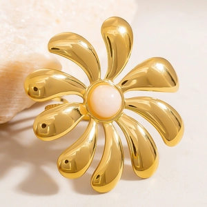 Macro view of 18k gold plated flower ring with natural opal stone and polished petals