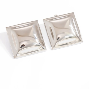 Macro view of polished 18k gold square earrings with high-gloss mirror finish surfaces