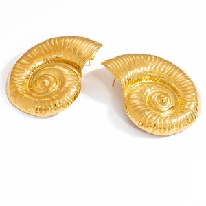 Macro view of 18k gold plated conch-shaped earrings showing fine spiral textures