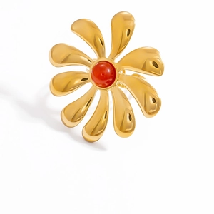 Macro detail of 18k gold plated flower ring featuring a vibrant red stone center
