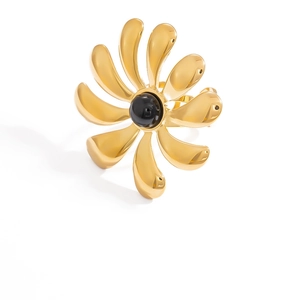 Detail of 18k gold plated stainless steel flower ring with black natural stone inlay