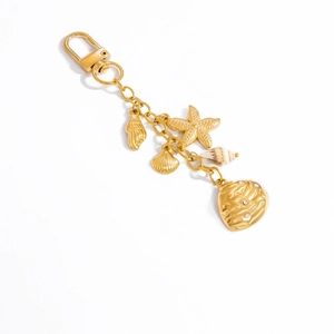 Detailed macro view of golden ocean shell keychain with starfish and shell pendants