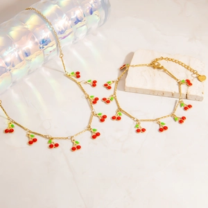 Two-piece gold stainless steel necklace and bracelet set with red enamel cherry charms