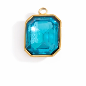 Detail view of emerald-cut blue crystal pendant with polished gold-plated bezel frame