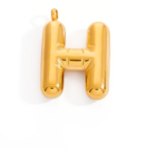 Macro shot of 3D gold-plated balloon letter H pendant for DIY necklace making