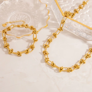 Parure collier et bracelet en acier inoxydable plaqué or 18 carats au design noué