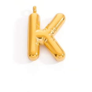 Macro detail of gold-plated K letter pendant with inflated balloon texture and glossy finish
