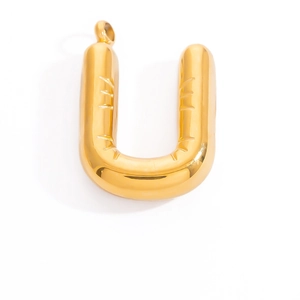 Detail shot of a polished golden puffy letter U charm with a shiny metallic finish for jewelry