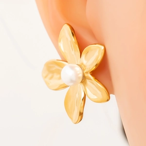 Detail of 18K gold flower stud earring with pearl center on ear model