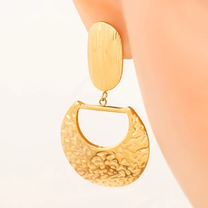 Detail of 18K gold-plated hammered metal drop earrings with vintage texture on a model
