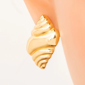 Detailed view of 18K gold plated conch shell earrings with spiral texture on ear model
