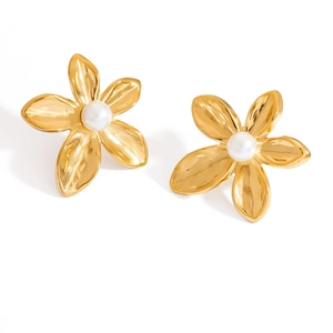 Close-up of 18K gold floral stud earrings featuring textured petals and white pearls