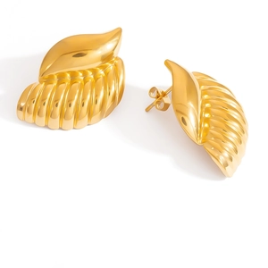 Macro shot of 18K gold plated seashell earrings with detailed wavy ocean textures