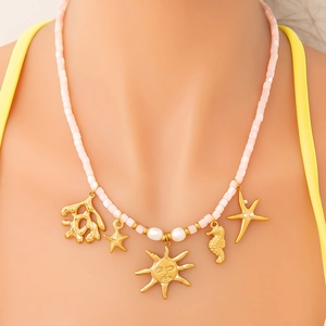Pink beaded summer necklace with golden sea charms and pearls on sun pendant chain