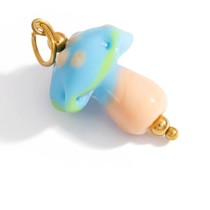Detailed macro of a cute blue mushroom pendant charm with colorful dots and gold loop