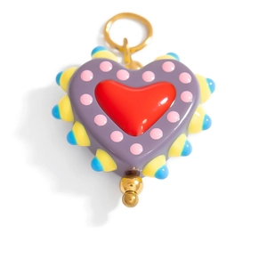 Detailed close-up of handmade purple heart pendant with colorful glaze and gold accents