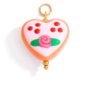 Detail of a heart-shaped resin pendant with 3D pink rose and gold-tone metal components