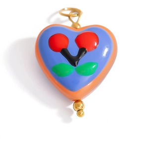 Detailed close-up of a handmade heart-shaped glass pendant with cherry pattern details