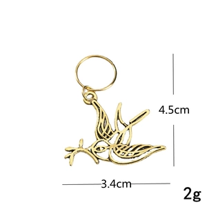 Detailed size view of a golden swallow bird pendant for dreadlocks and hair jewelry