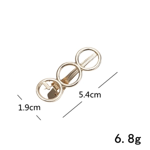 Detail view of a gold hollow geometric hair clip showing 5.4cm length and 1.9cm width