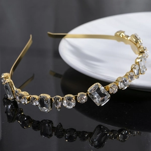Sparkling gold metal headband with geometric crystal embellishments in a minimal thin design