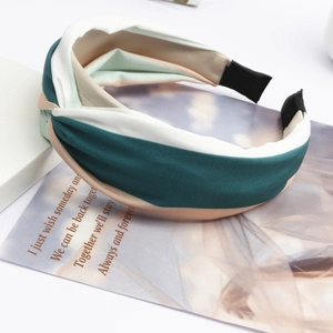 Elegant wide striped crossover headband in green, cream, and apricot fabric twist knot