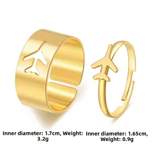 Gold airplane couple rings detail showing 1.7cm and 1.65cm inner diameter dimensions