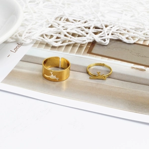 Close-up of gold animal hollow couple rings with adjustable opening on magazine