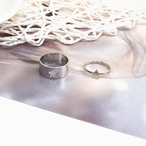 Detail of adjustable vintage silver couple rings with hollow star and solid star designs