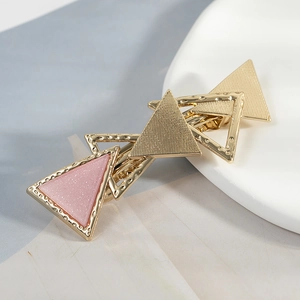 Golden geometric hollow triangle hair clip with pink glitter accents for women