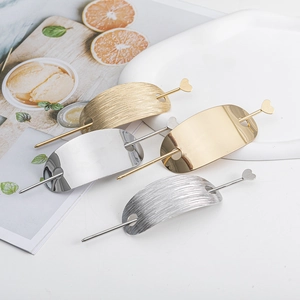 Sleek metal hair stick set in gold and silver with heart charm and oval clips