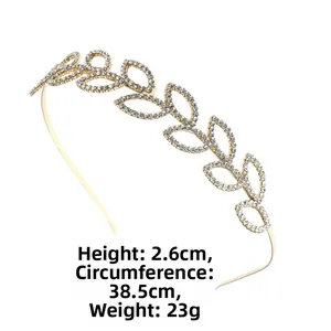 Detail view of a luxury gold leaf headband adorned with sparkling clear rhinestones