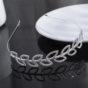 Elegant silver leaf headband with shimmering rhinestones for women on black mirror surface