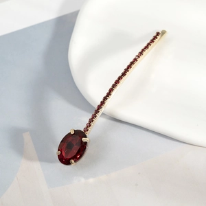 Elegant gold hairpin with a large oval red crystal and sparkling small rhinestones