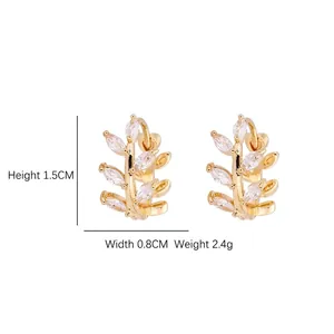 Elegant gold leaf hoop earrings with micro-inlaid marquise zircons in a branch design