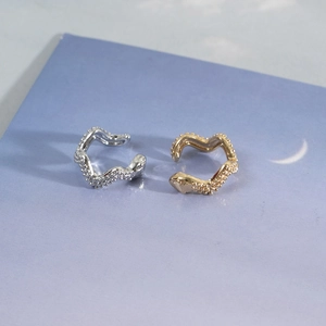 Irregular wave-shaped ear cuffs with zircon micro-paving in gold and silver finishes