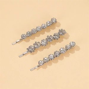 Lot de trois barrettes argentées avec strass étincelants et motifs de fleurs en zircon