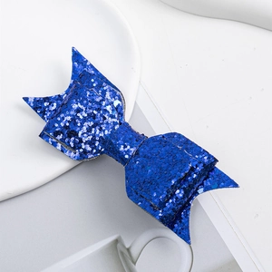 Detailed macro view of bright blue glitter hair bow with layered sparkling sequin texture