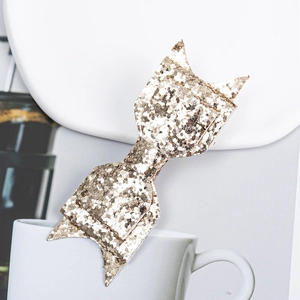 Sparkly gold glitter bow hair clip with cat ear and fishtail design for children