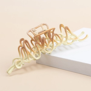 Gradient matte claw clip in cream yellow and caramel brown on white geometric prop